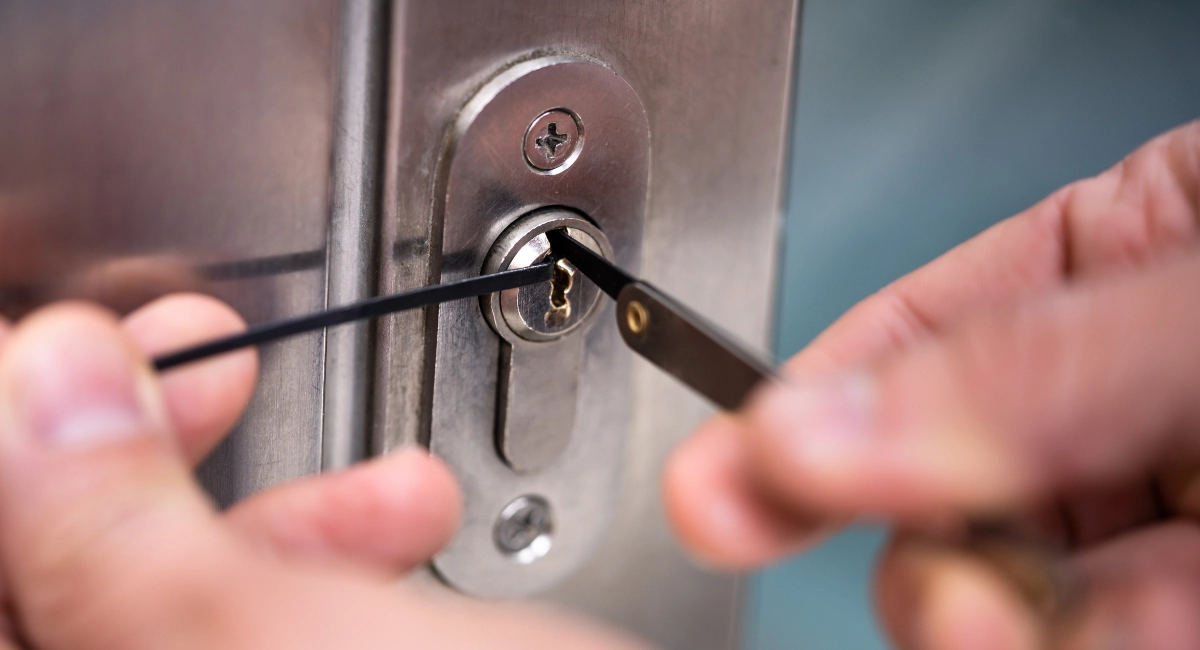 A locksmith picking a residential door lock