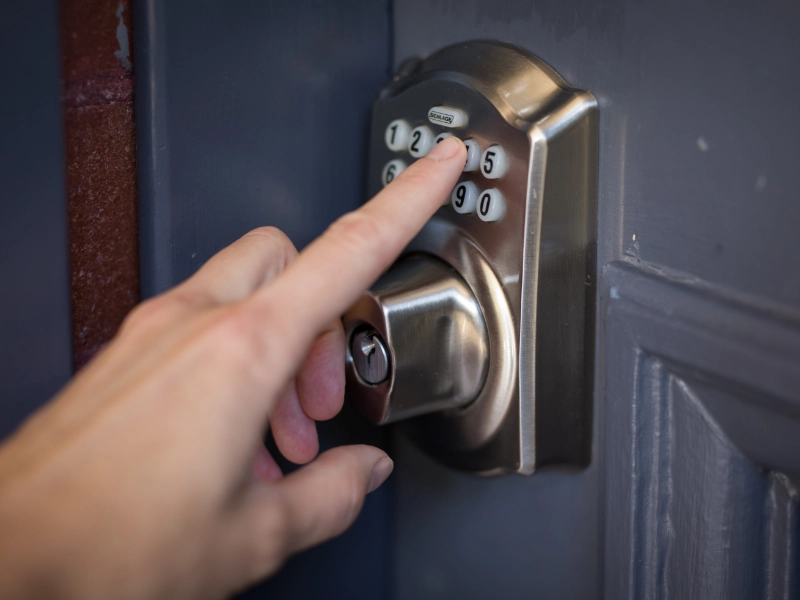 Someone entering a code on a keypad